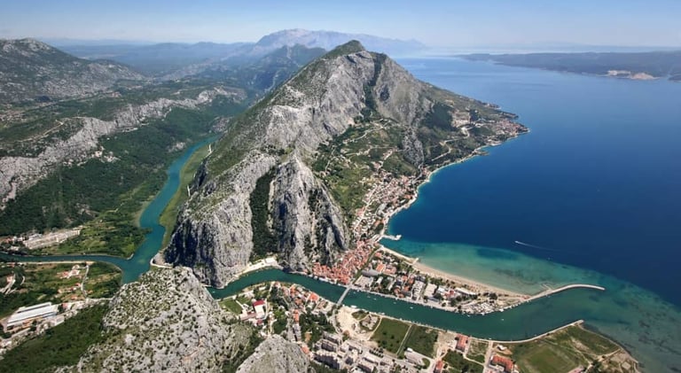 The photograph shows the city of Omis from the air perspective.