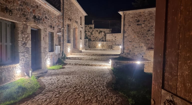 a stone building with a stone walkway and steps leading up to a building