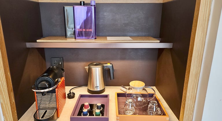 Andaz Singapore room amenities with reusable water bottle and complimentary coffee and tea