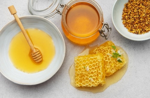 a bowl of honeycomb and honey