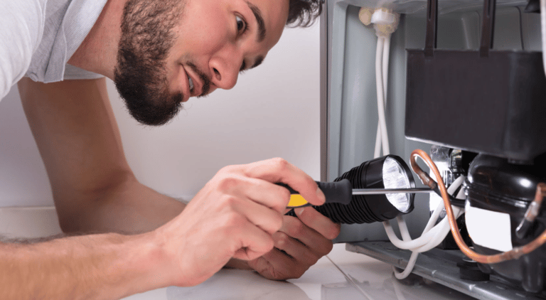 a man in a white shirt is looking at a computer screen