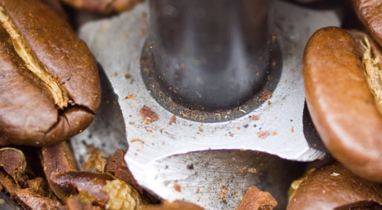 a spoon with coffee beans and coffee beans
