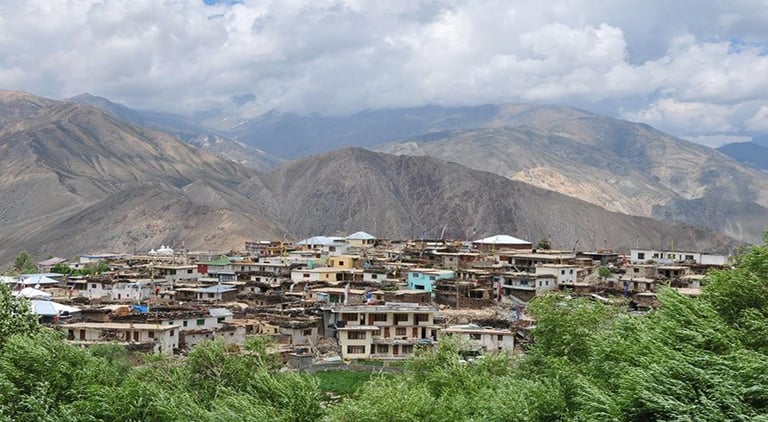 a mountain village in the mountains with a view of the mountains