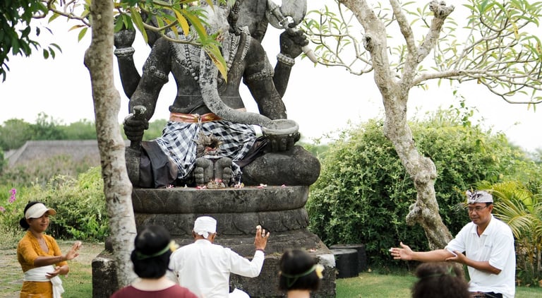 family participating in traditional Balinese blessing ceremony during a private retreat in Bali