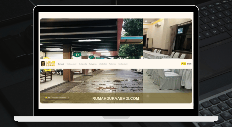 Tampilan Website Rumah Duka Abadi ditampilkan pada layar laptop.