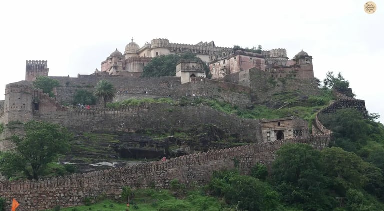 View of Kumbhalgarh Fort’s massive fortification walls winding through the Aravalli hills in Rajasthan.