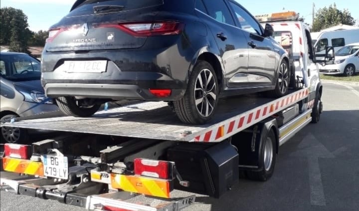 a car being towed on a flatbed trailer