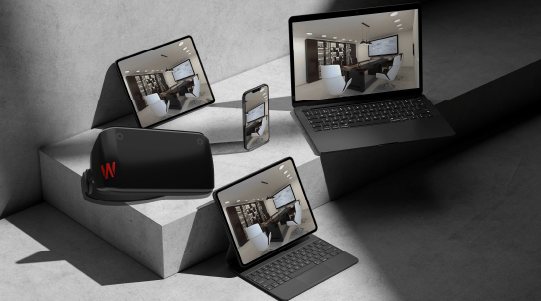 Modern devices including a laptop, tablet, smartphone, and VR headset arranged on a geometric surfac