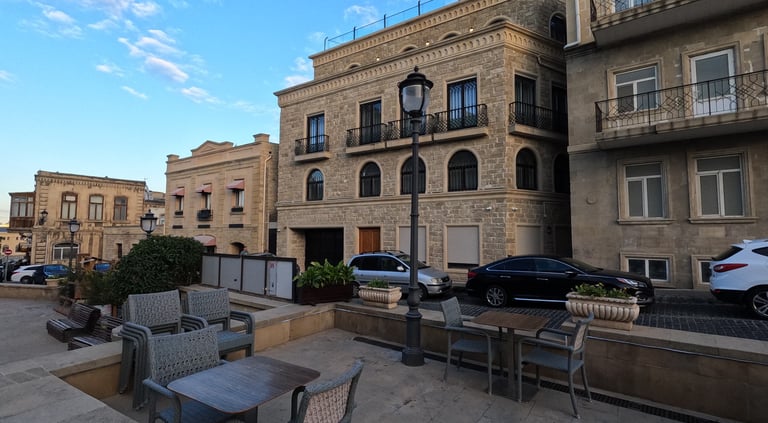 a table with chairs and chairs in front of a building