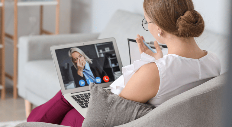 a woman sitting on a couch with a laptop computer