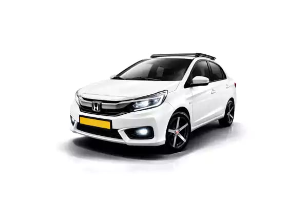 White Honda Amaze one way taxi by Saini taxi services with a luggage carrier rack