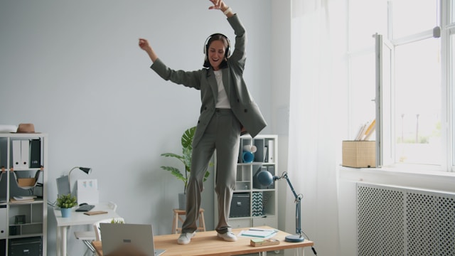 A person dancing as an exercise snack during a workday break.