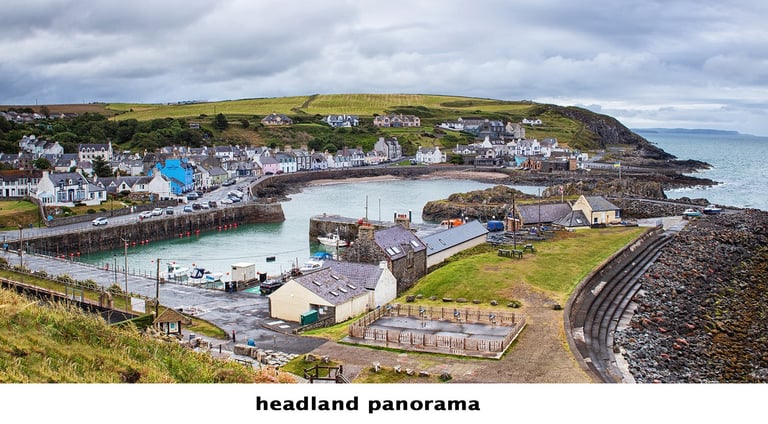a view of portpatrick, a scottish town with a harbour and boats in the water