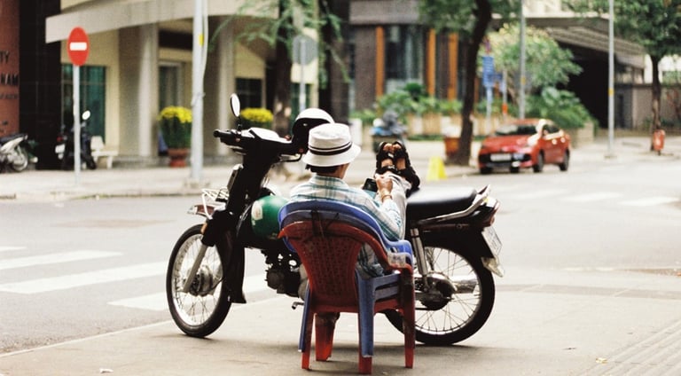 Motorbike driver resting on the street in Saigon