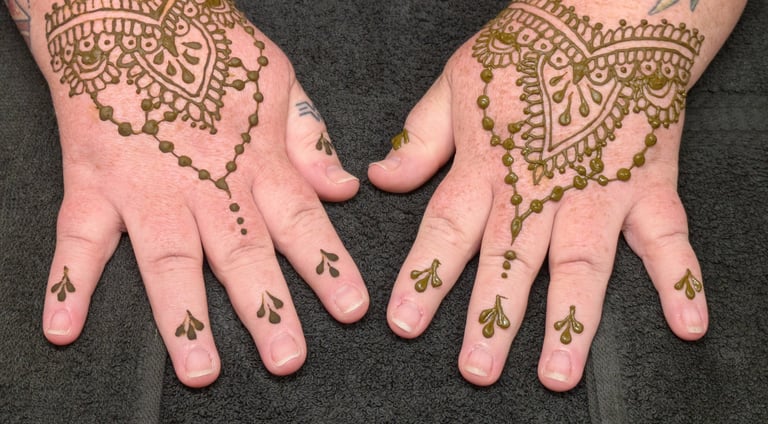 Ornate henna tattoo patterns in brown ink applied to the back of hands and fingers.