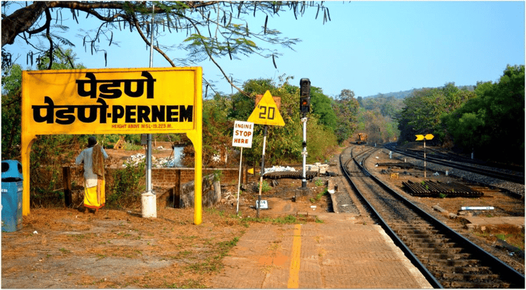a pernem train station with a sign board