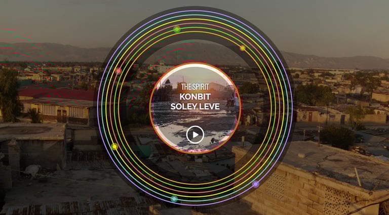 Website with colored circles; text: “The Spirit: Konbit Anba Soley” before Haiti’s Sunset of Soleil.