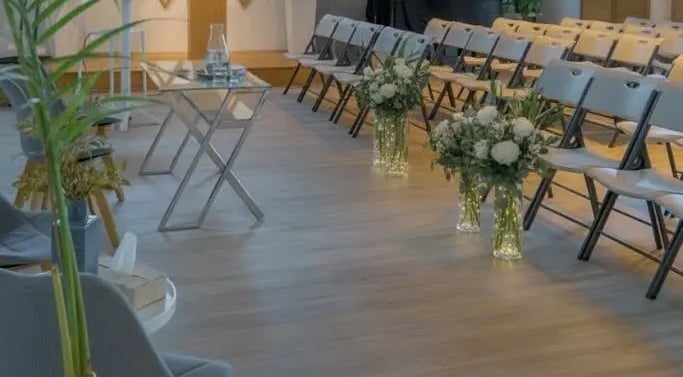 a room with chairs and tables and plants