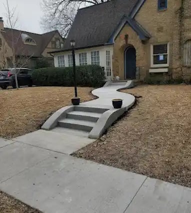 a house with a driveway with steps leading up to a driveway