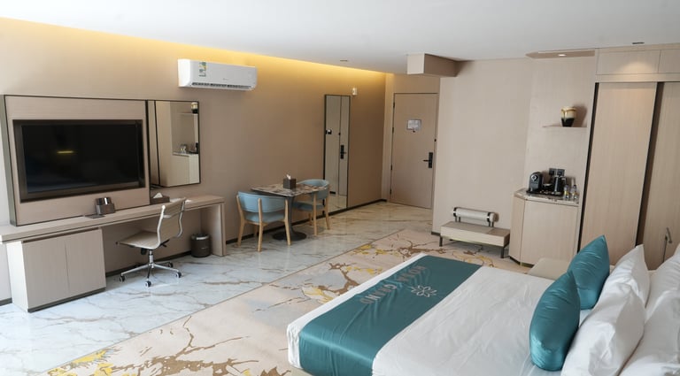 Deluxe room at Rosa Grand Granada Riyadh with modern furniture