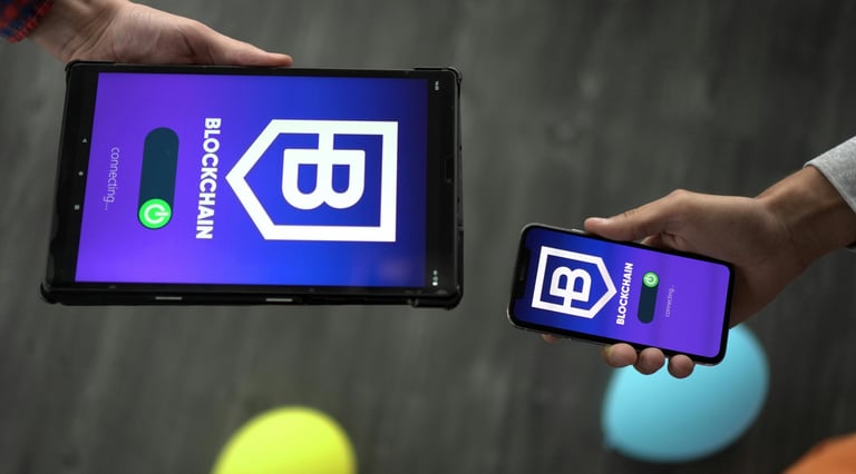Tablet and Smartphone with "Blockchain" Appearing on Screens