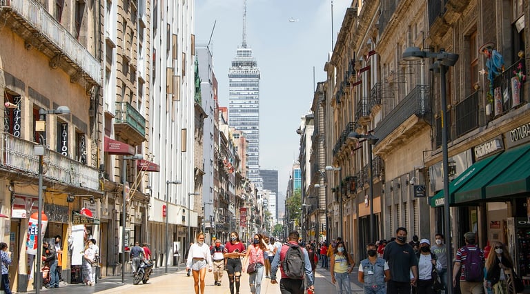 a city street scene with people walking down a street