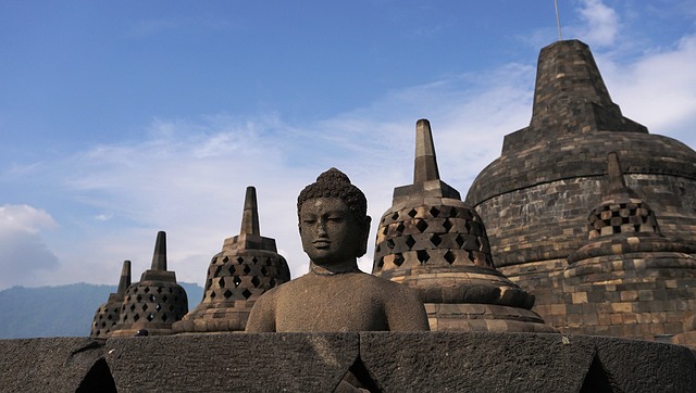 a buddha statue in front of a large buddha statue