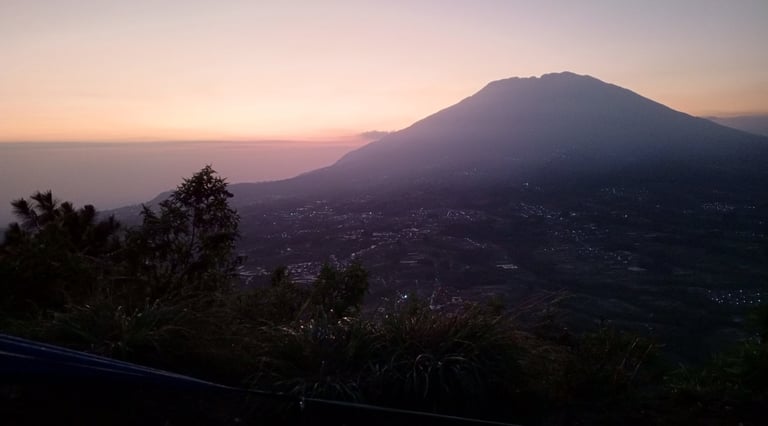 a mountain view of a mountain range at sunset