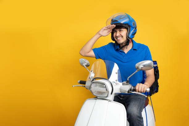 a man in a helmet and helmet on a scooter
