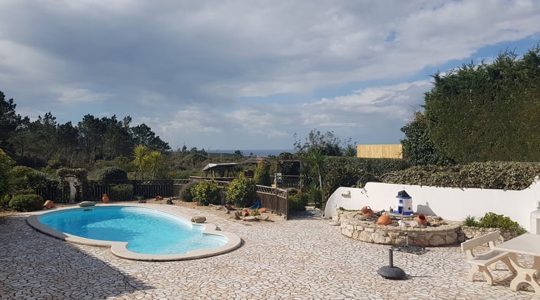 a pool with a stone patio area