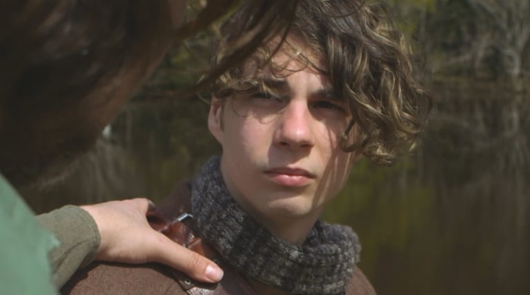 a man in a scarf around his neck