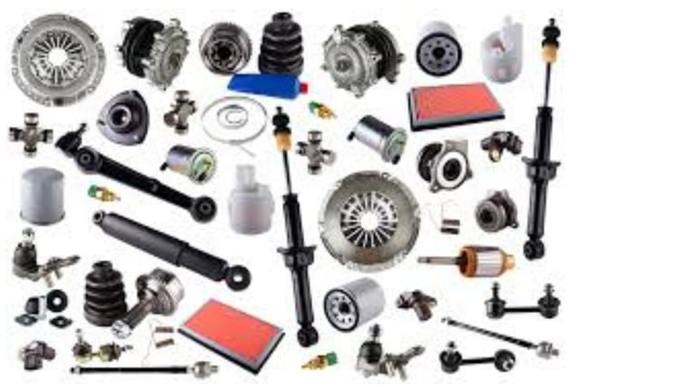 A collection of various car parts including shock absorbers, air filters, and engine components for auto repair.