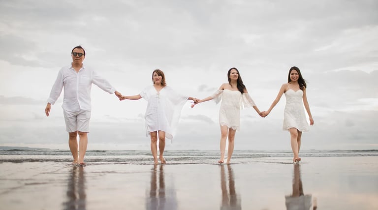 Janice family holding hands on the beach during a family photography session at Indigo Seminyak Bali