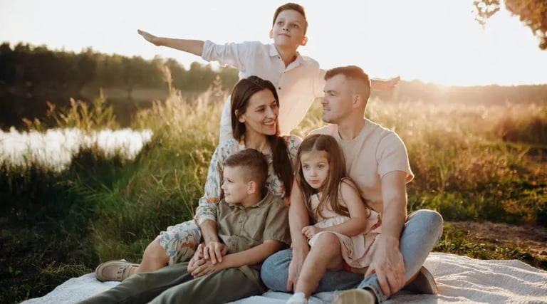 large young happy family at sunset