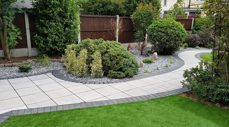 Patio with custom stone circle with aggregates and paving weaving through adventurous garden design