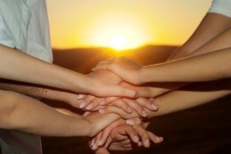 a group of people holding hands in a circle