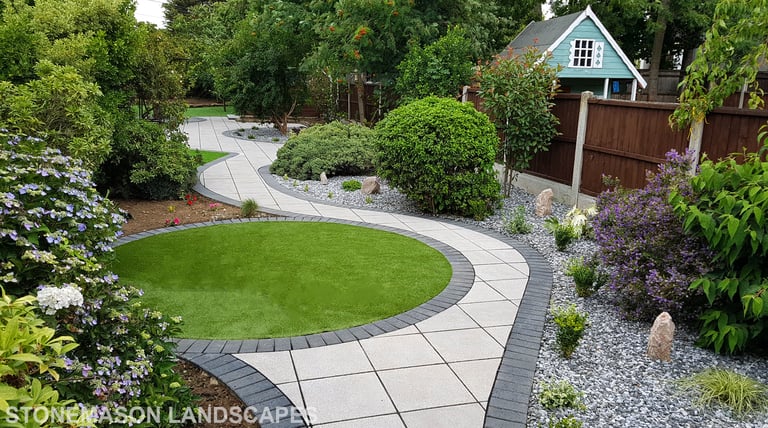Patio with custom stone circle with aggregates and paving weaving through adventurous garden design