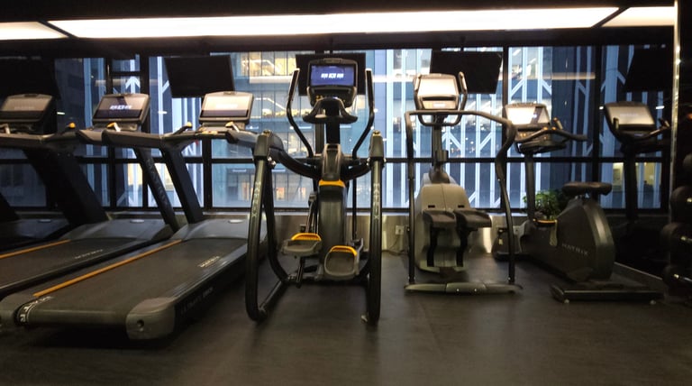 a gym room with a lot of exercise equipment