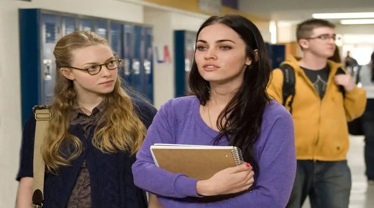 a woman in a purple sweater and glasses is holding a notebook and a notebook