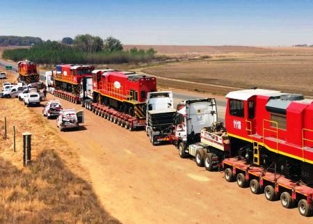 a train is being loaded with a trailer