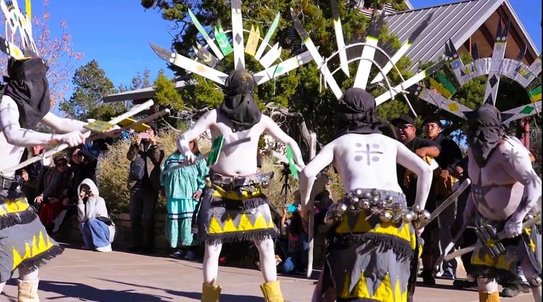 people in ceremonial costumes performing on at Grand Canyon National Park