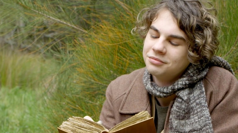 a man in a brown jacket is holding a book