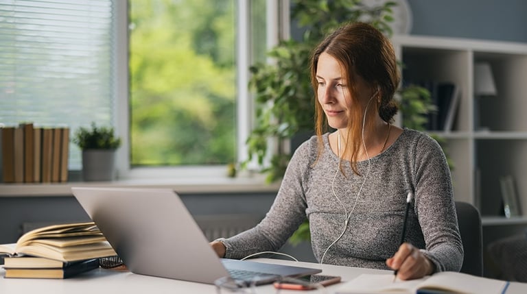 Adult learner researching education options on a laptop