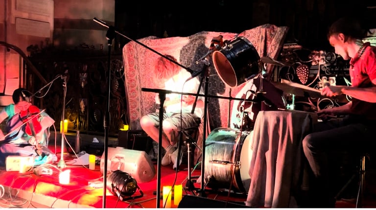 A picture of artists in violin, drums and guitar