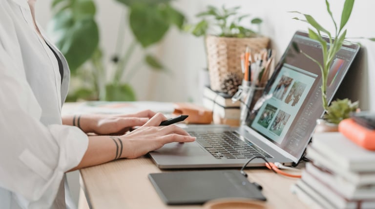 woman sitting at desk working on her laptop
