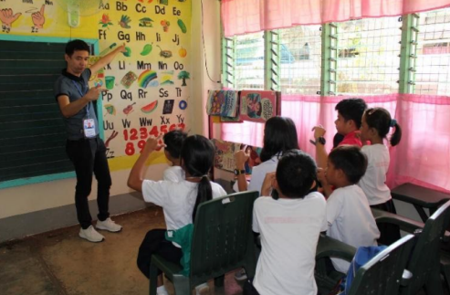 a teacher teaching children in a classroom