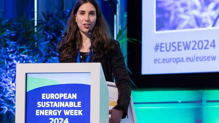 a woman in a black jacket speaking at the european sistainable energy week 2024