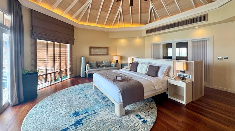Baros Maldives overwater pool villa bedroom