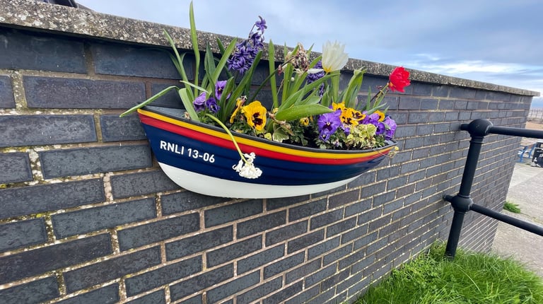 Planter outside the lifeboat men outside the lifeboat station in Hoylake