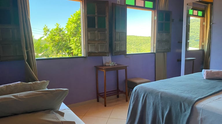a bedroom with a bed and a table with pillows
